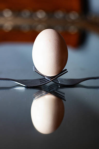 A simple and elegant composition of fresh brown eggs placed on a weathered wooden table, bathed in soft natural light. This organic still life evokes themes of farm freshness, healthy eating, and homemade cooking. Perfect for food blogs, organic product packaging, Easter campaigns, or rustic kitchen decor. The textured background and warm tones create a cozy, inviting atmosphere