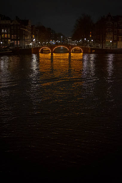 A canal at night with decorative lighting with no people