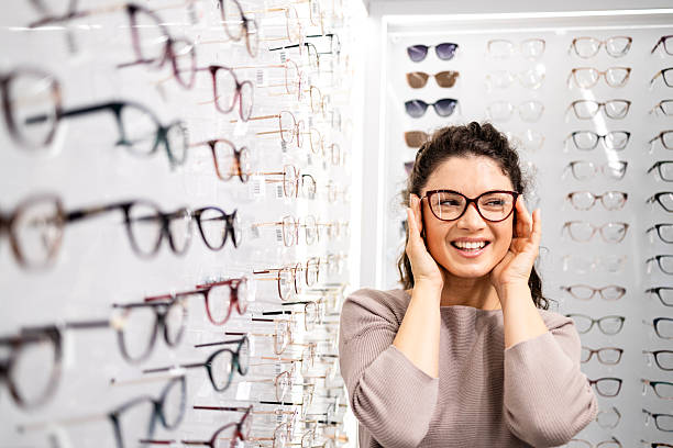 istock Trying on new eyeglasses in optician store. 2213056272