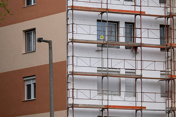 istock Vertical view of apartment building under renovation with scaffolding 2213057840