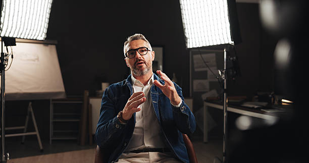 mature man, discussion and screen with interview for talk, design tutorial or development process. male person, civil engineer or building designer with recording for helpful tips, lesson or guide - arbetsstudio bildbanksfoton och bilder