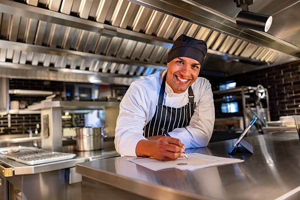 istock Happy chef bookkeeping at a restaurant and smiling 2213060061