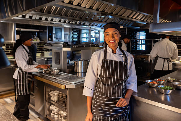 istock Female chef working in a commercial kitchen at a restaurant 2213060071