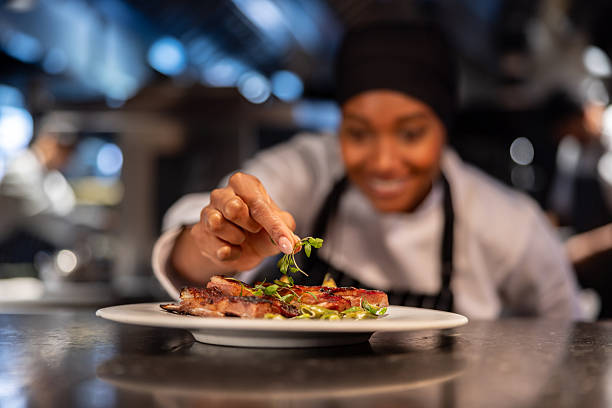 istock Close-up on a chef decorating a plate at a restaurant 2213060095