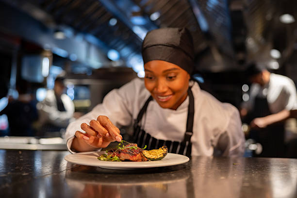 istock Chef decorating a plate while cooking in a commercial kitchen 2213060120