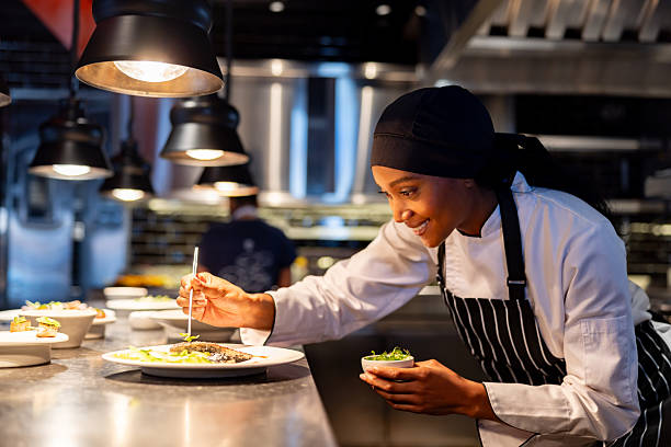 istock Chef decorating a plate while serving food at a commercial kitchen 2213060126