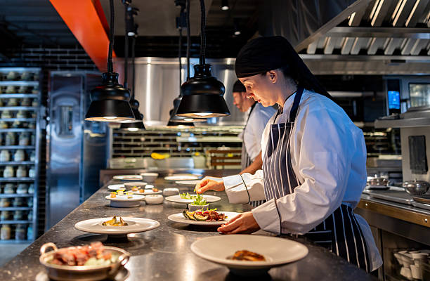 istock Chef working at a restaurant and decorating plates on the kitchen counter 2213060154