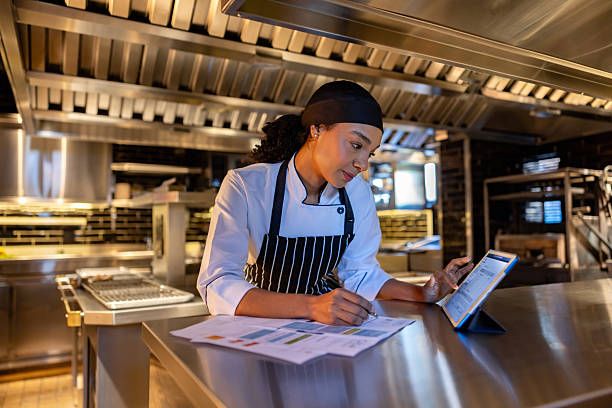 istock Chef paying bills in the kitchen while working at her restaurant 2213060181