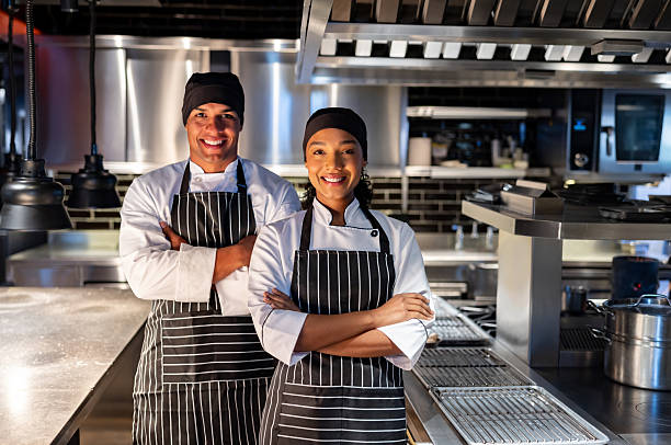 istock Team of chefs smiling at a restaurant 2213060189