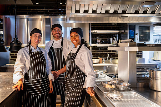 istock Happy group of cooks smiling while working at a restaurant 2213060205