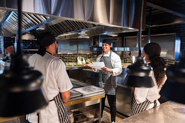 istock Chef explaining the menu to a group of cooks at a restaurant 2213060219