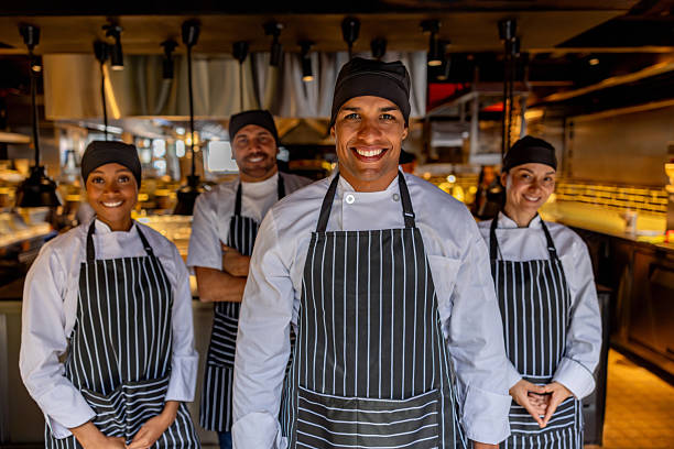 istock Happy group of chefs smiling at a restaurant 2213060257