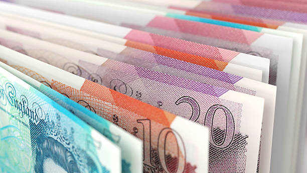 Close-up view of British pound banknotes in different denominations, emphasizing UK currency and finance