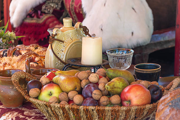 istock Rustic harvest feast with fruits, nuts, and warm decor 2213061356
