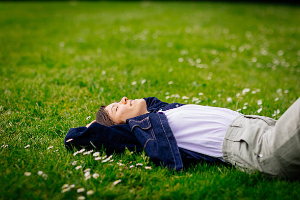 istock Beautiful woman relaxing on a grass 2213061395