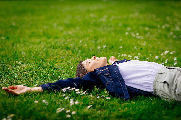 istock Beautiful woman relaxing on a grass 2213061434