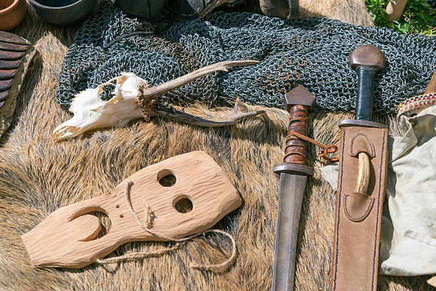 istock Medieval artifacts display with sword and wooden mask on fur and chainmail 2213061447