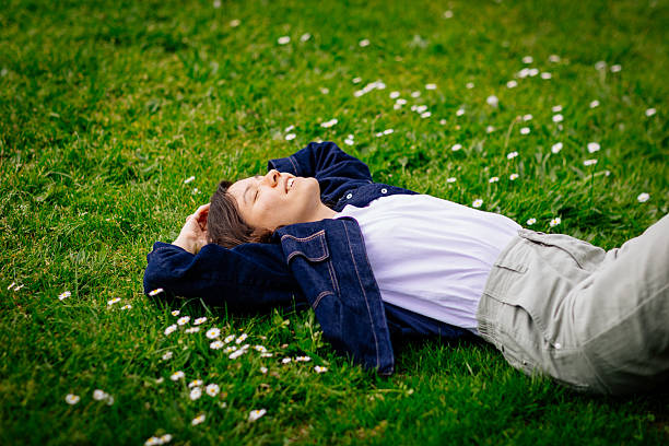istock Beautiful woman relaxing on a grass 2213061469