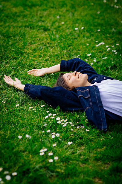istock Beautiful woman relaxing on a grass 2213061504