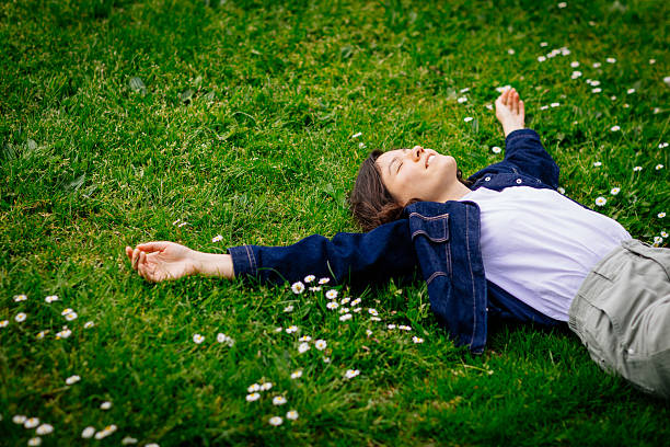 istock Beautiful woman relaxing on a grass 2213061535