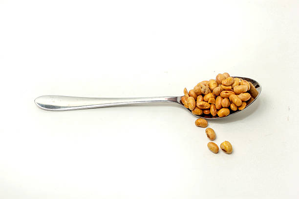 istock Fried soybean snack, on a spoon, on a white background 2213061564