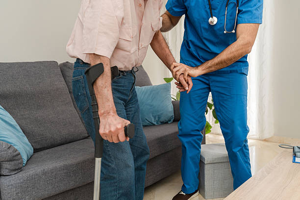 istock Close up of Nurse assisting elderly man using crutches at home 2213062981