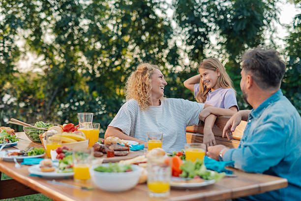 istock Happy family enjoying a backyard barbecue together 2213063477