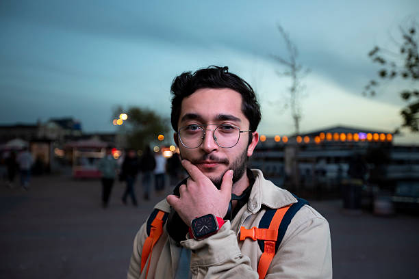 istock A young man walking in the evening light. 2213065175