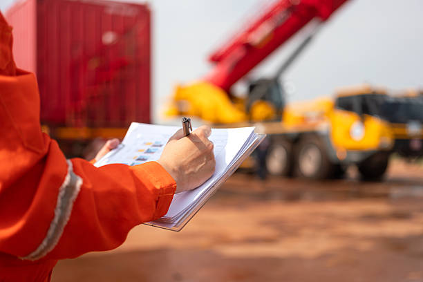 istock Checking on safety checklist form of crane. Industrial working. 2213067876
