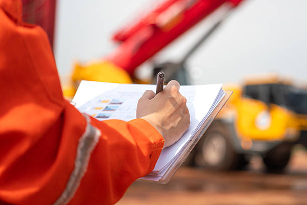 istock Checking on safety checklist form of crane. Industrial working. 2213067911