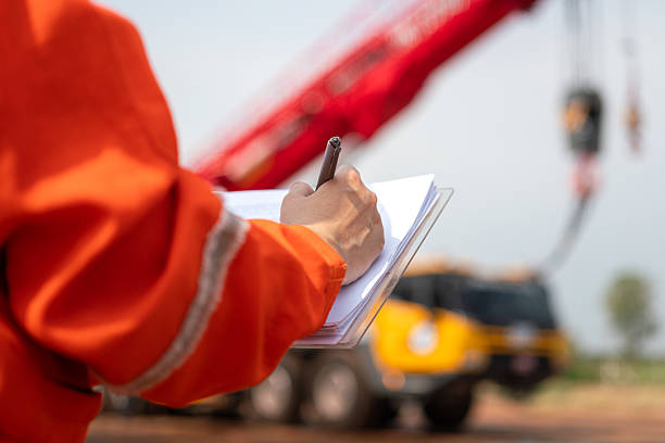 istock Checking on safety checklist form of crane. Industrial working. 2213067912