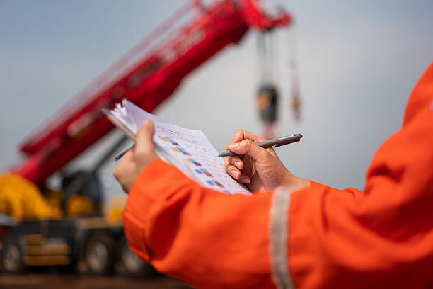 istock Checking on safety checklist form of crane. Industrial working. 2213068007