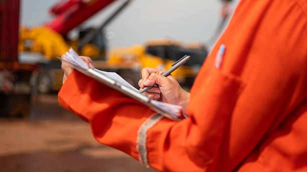 istock Checking on safety checklist form of crane. Industrial working. 2213068026