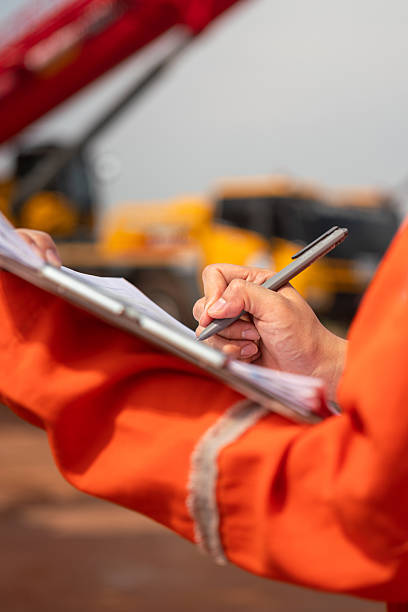 istock Checking on safety checklist form of crane. Industrial working. 2213068028