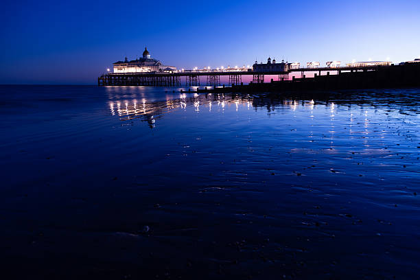 Eastbourne pier at night clear sky water reflection East Sussex England Europe