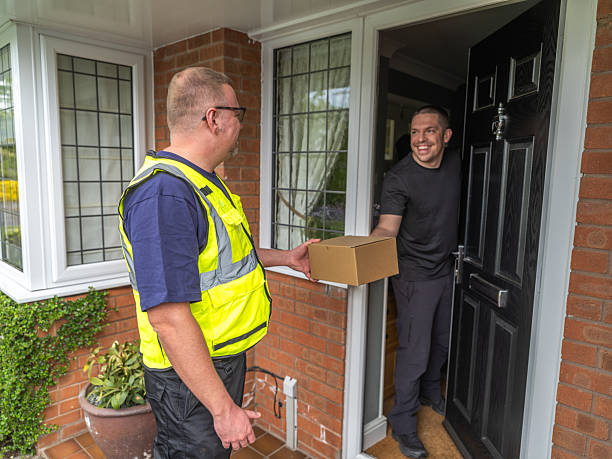 istock Courier Handing Package to Resident 2213074236