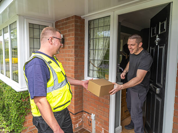 istock Courier Handing Package to Resident 2213074294