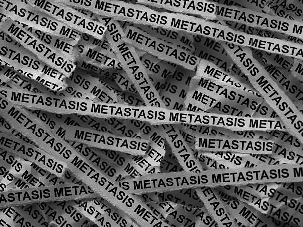 Strips of newspaper with the words Metastasis typed on them. Black and white.