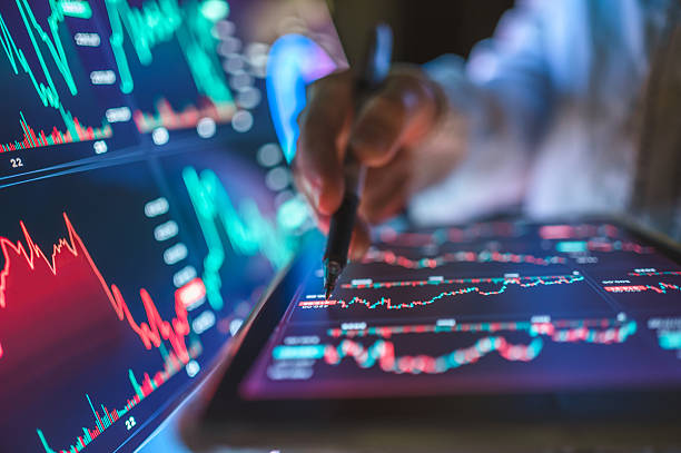 istock Hand using pen to interact with digital tablet showing candlestick chart, financial statistics, and real-time trading analytics, modern online stock trading environment for financial planning 2213076024