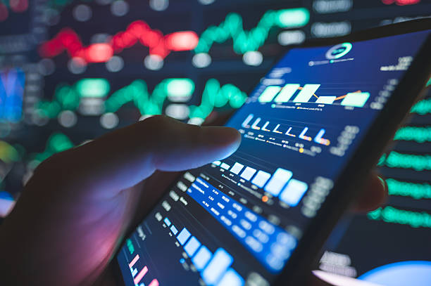 istock investor hand holding mobile device with data visualization of performance metrics, digital investment interface, stock trading background with market movement 2213076044