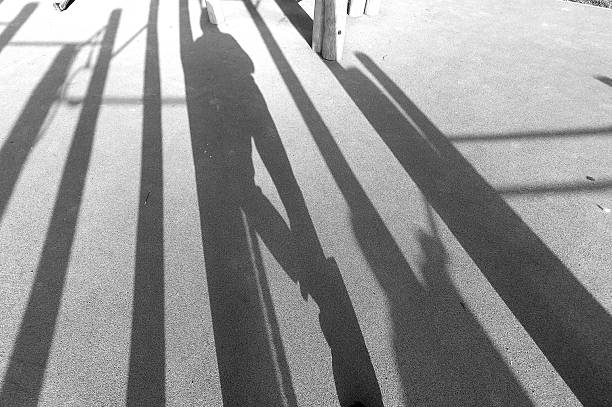 istock Shadows from a man on the road 2213079108