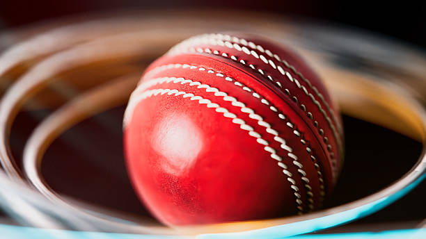 Classic red cricket ball isolated on white background table view isolated on white background.