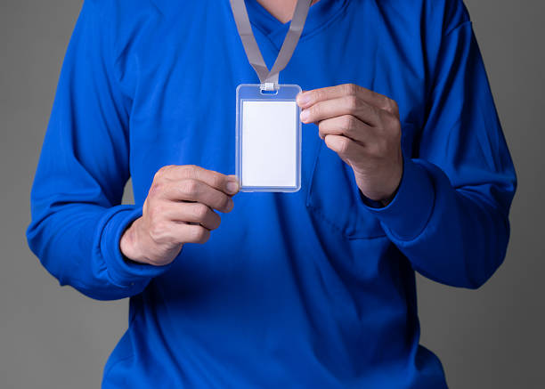 istock man holding id tag on brown background 2213082469