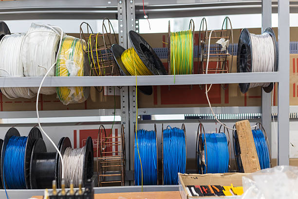 istock Colorful electrical wire spools storing on metal shelves in warehouse 2213082709