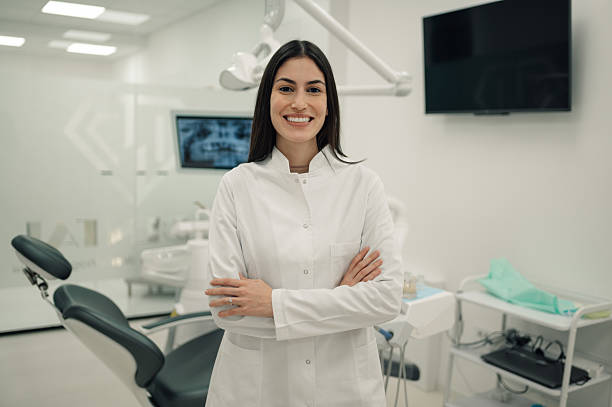 istock Young female dentist smiling at the camera in her office 2213087065