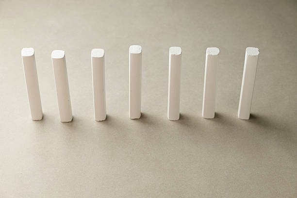 istock White chalk pieces arranged in a perfect row on a smooth surface 2213089141