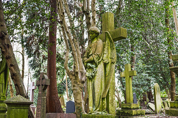 Weathered stone sculpture of an angel in a cemetery