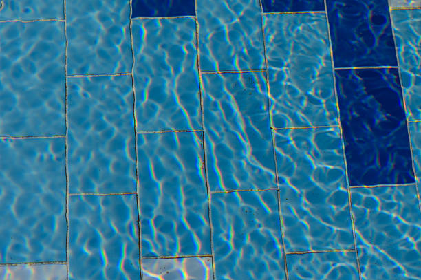 Gentle ripples on crystal-clear pool water, creating a calm and peaceful background. Ideal for showcasing relaxation and luxury.
