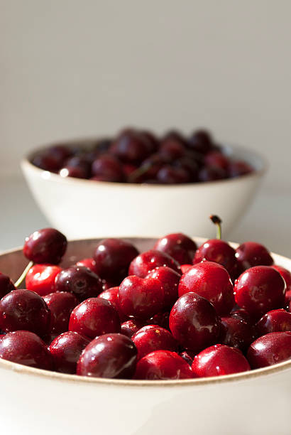 istock Red cherries on a plate close up 2213094599