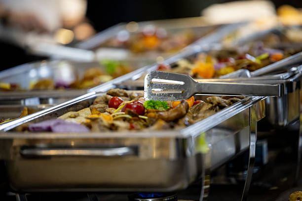 istock Buffet setup with various dishes displayed at an event in a banquet hall during a lively gathering 2213095610